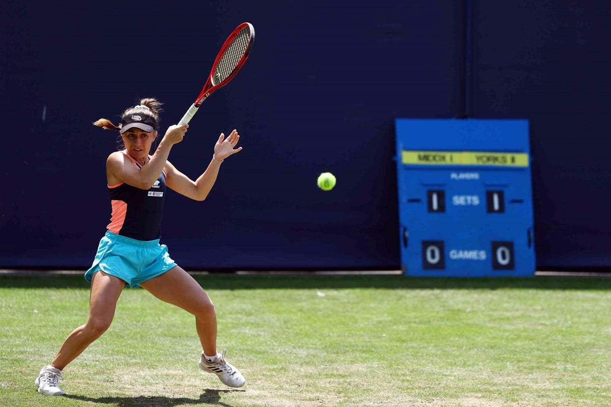 Singles player hitting a ball in game.jpg